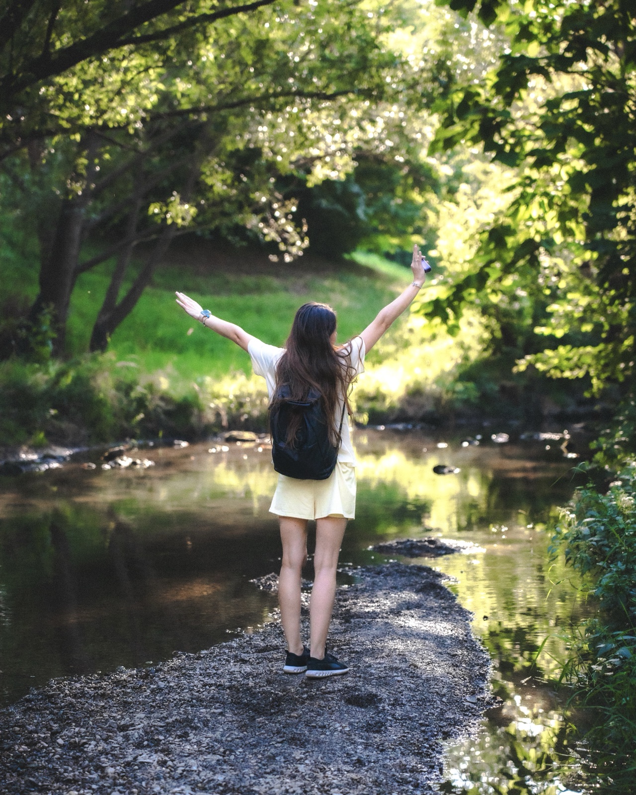 Girl by the stream, arms raised — Best Alex Shots, Vienna